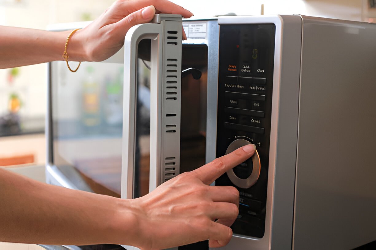 microwave oven door and preparing food in microwave