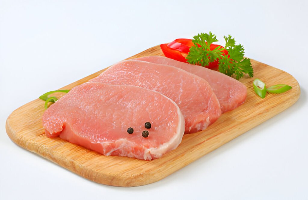 raw pork loin chops with spices-on-a-cutting-board