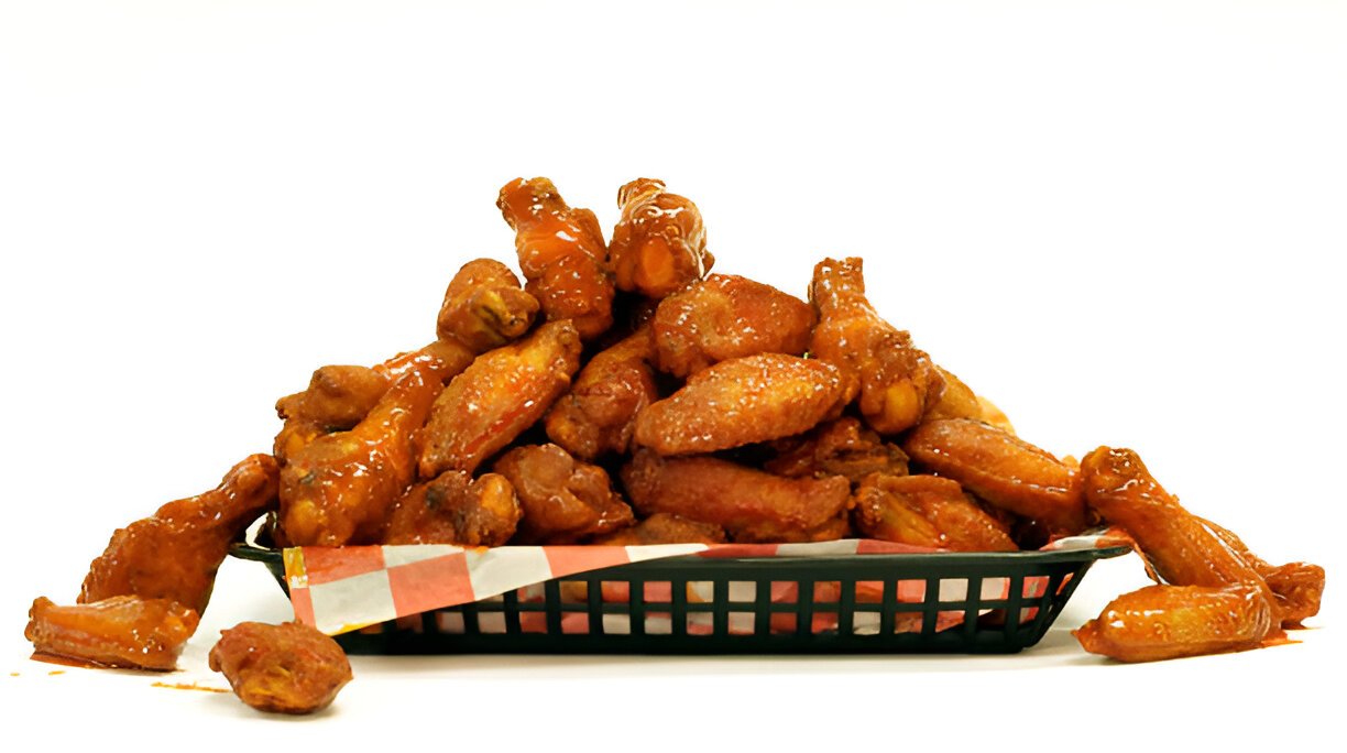 spicy glazed chicken wings in a black basket