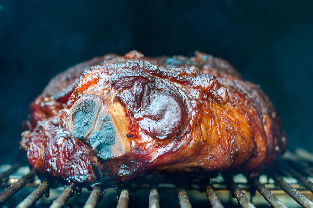 pork shoulder getting smoked for pulled pork