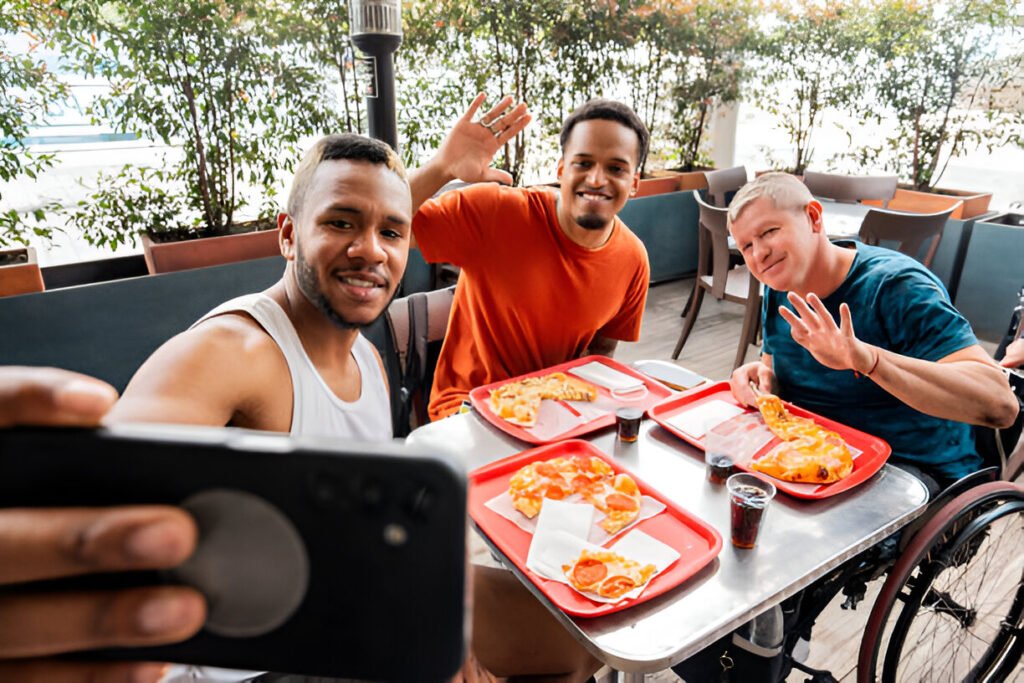 friends filming or on a video call and eating pizza at restaurant