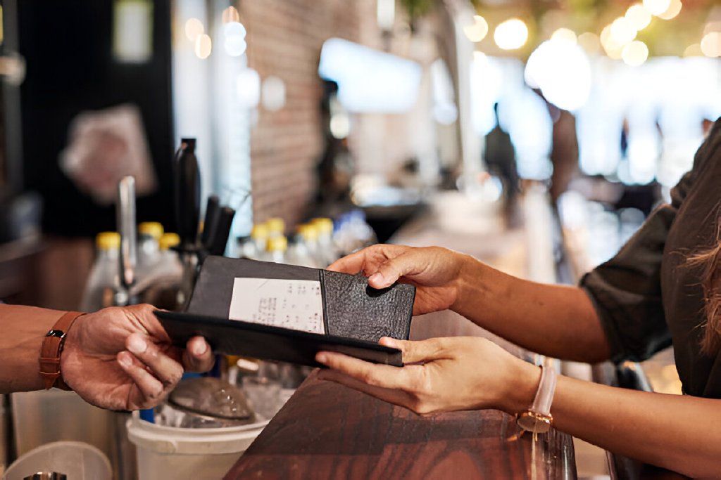hands with bill food service and people in restaurant customer with receipt