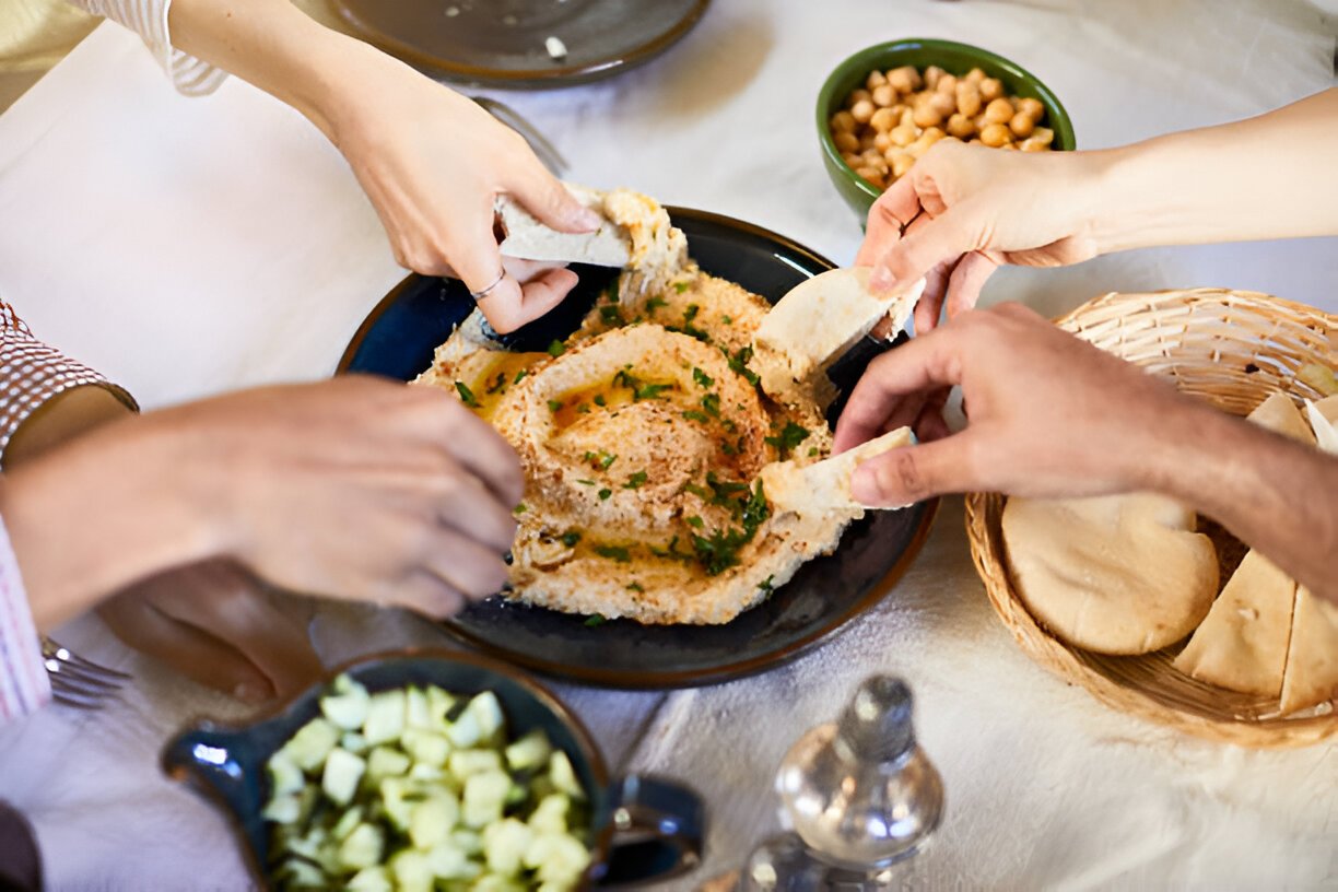 vegan food hands dipping hummus