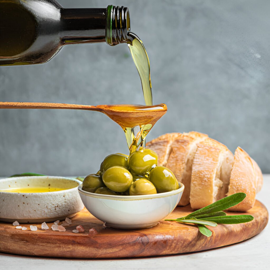 pouring olive oil over green olives