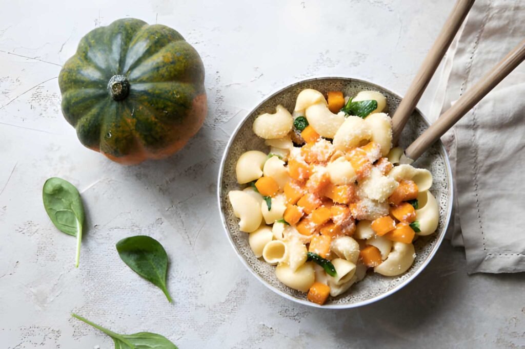 bowl of pasta with pumpkin spinach and cheese